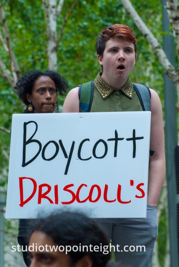 2015 Seattle May Day Immigrant Rally, Woman Holding Boycott Driscoll's Poster