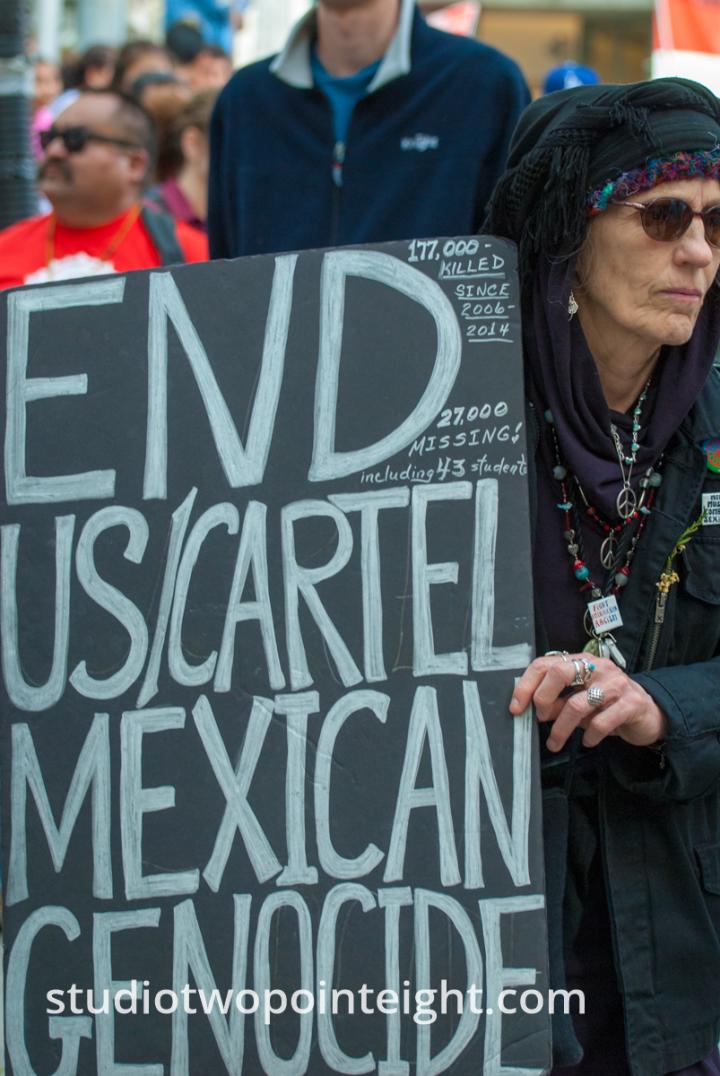 2015 Seattle May Day Immigrant Rally, Woman Holding End Cartel Sign