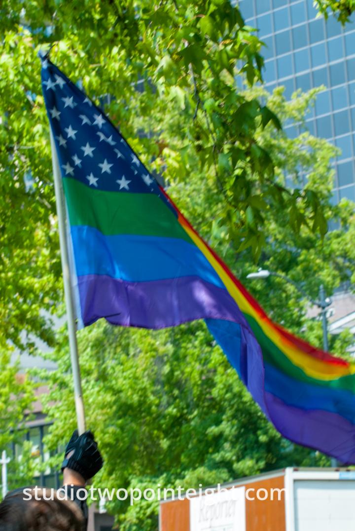 Seattle, August 18, 2018, Liberty or Death Rally Counter Protester Waved an LGBTQ Flag