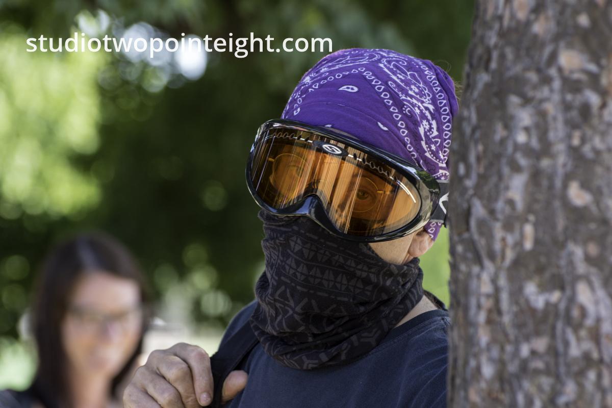 Studio 2.8, During Seattle Liberty March, A Masked and Goggled Anarcho-Communist Counter-Protester Posted For A Telephoto Lens Portrait