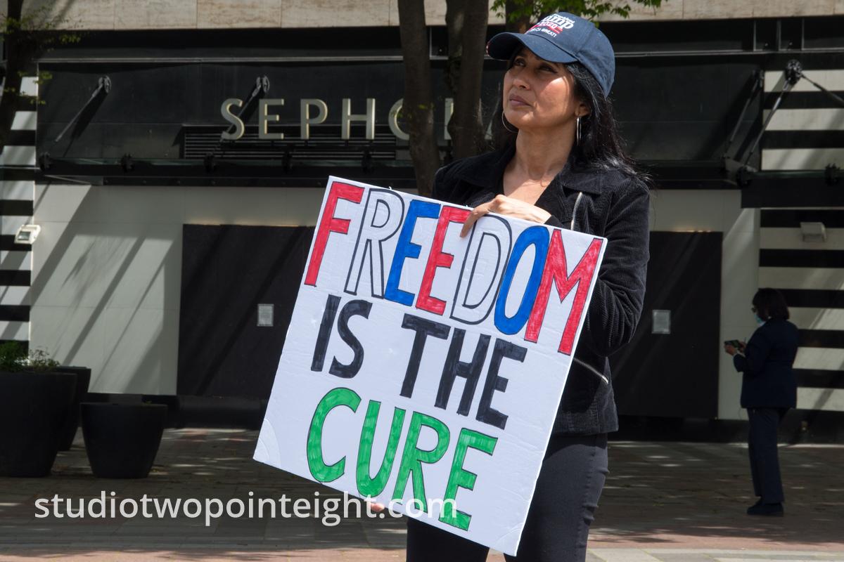 Studio 2.8, May 1, 2020, Seattle May Day End Coronavirus Lockdown Protest, Woman Displays Freedom Is The Cure Poster