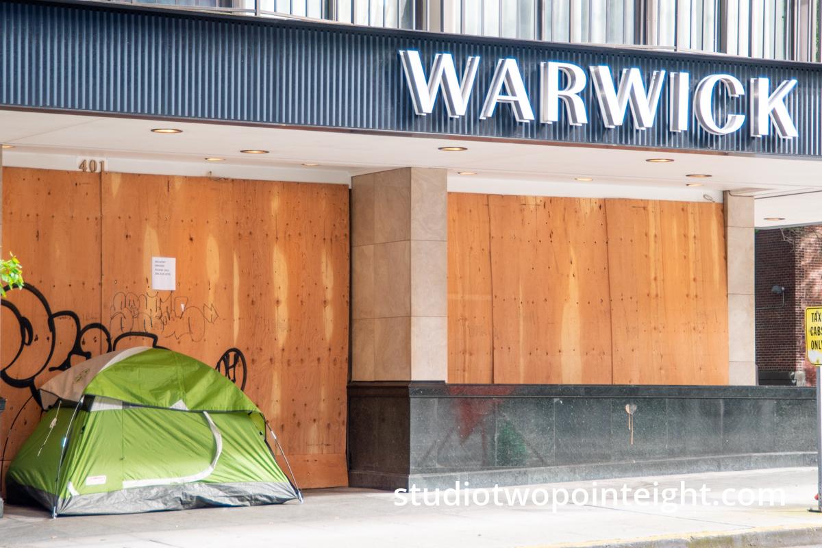 Studio 2.8 Documenting The 2020 Corona Virus Pandemic, Homeless Person Tent Camping Outside Closed, Boarded Up, Warwick Hotel