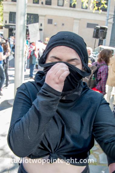 Seattle May 1, 2019 May Day Immigration Rally Female Marxist Antifa Black Bloc Terrorist Adjusts Disguise